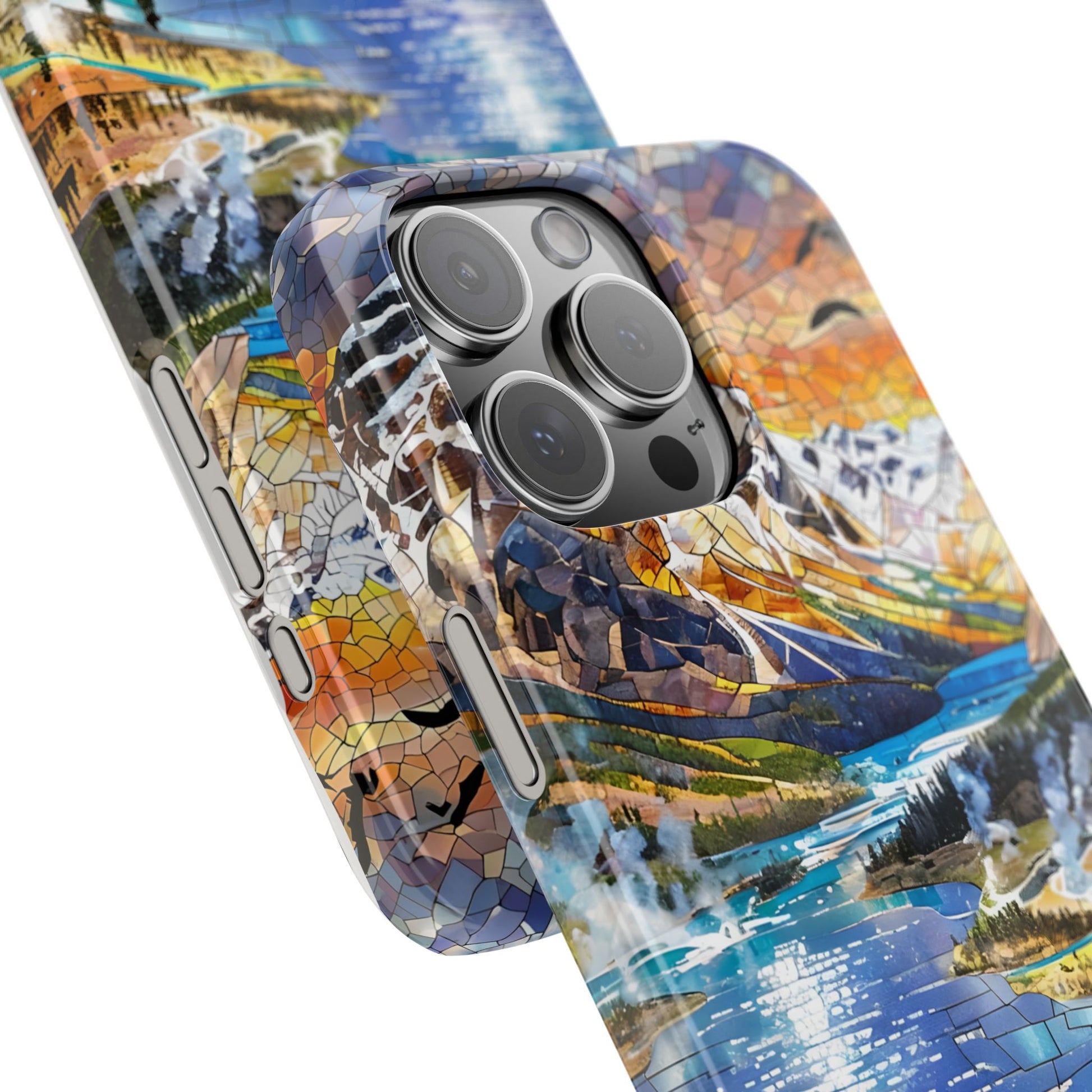 May include: A smartphone with a colorful case featuring a mosaic-style landscape design. The case showcases a lake, mountains, and trees in shades of blue, green, orange, and brown. The phone has a black camera module.