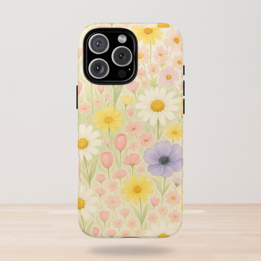 May include: Clear phone case featuring a watercolor floral design. The case displays a field of daisies, tulips, and other flowers in shades of yellow, pink, and purple. The phone case has a clear border.